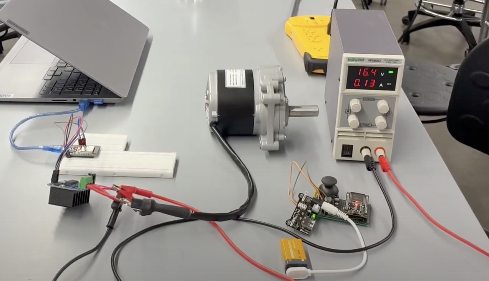 Bench test of a single motor and driver branch with a lab power supply, breadboard, and joystick input